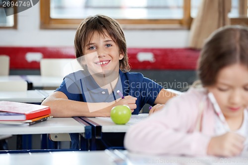 Image of Portrait Of Happy Schoolboy Drawing At Classroom