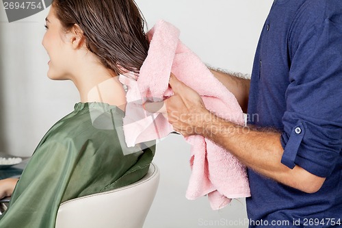 Image of Hairstylist Drying Client's Hair At Salon