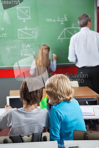 Image of Little Schoolboys Using Digital Tablet At Desk