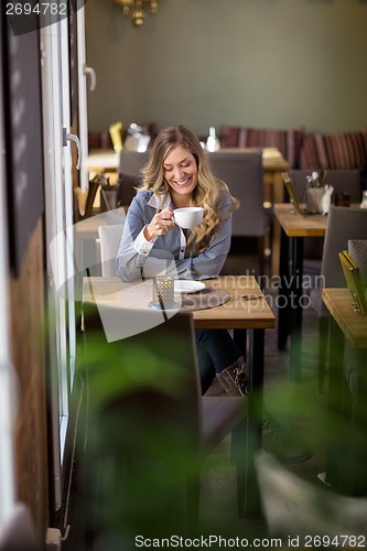 Image of Woman Having Coffee At Cafe