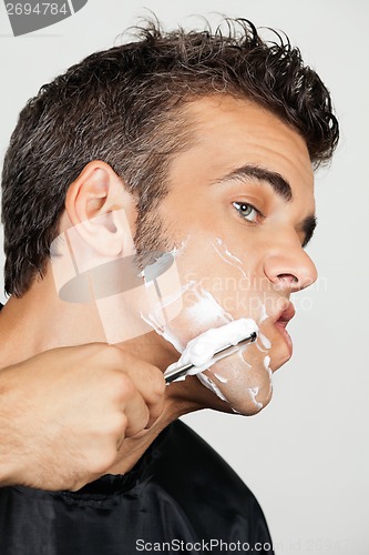 Image of Mature Man Shaving His Face