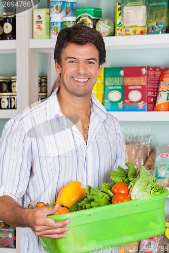 Image of Man With Vegetable Basket In Grocery Store