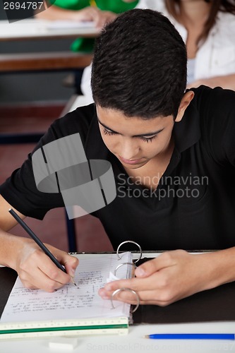 Image of Student Copying From Cheat Sheet At Desk