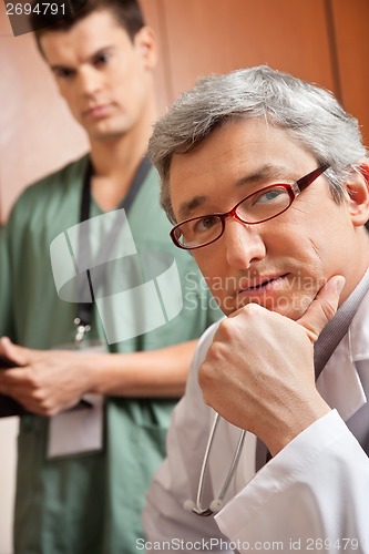 Image of Male Doctor With Hand On Chin