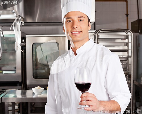 Image of Young Chef Holding Wine Glass