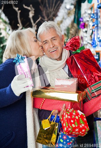 Image of Woman Kissing Man At Christmas Store