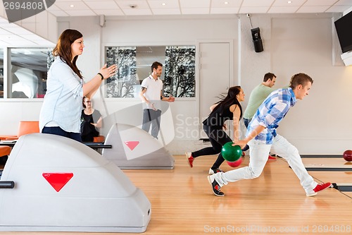 Image of Friends Bowling Together in Club