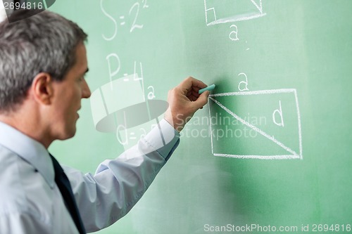 Image of Male Professor Writing On Greenboard