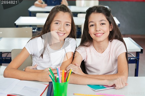 Image of Schoolgirls Sitting At Desk In Classroom