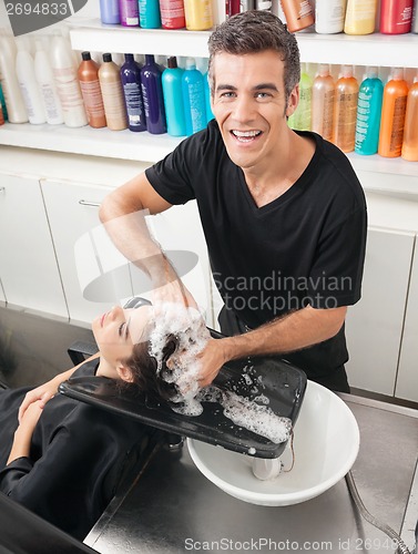 Image of Hairstylist Washing Customer's Hair