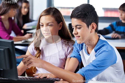 Image of Boy With Female Friend Pointing At Computer Screen