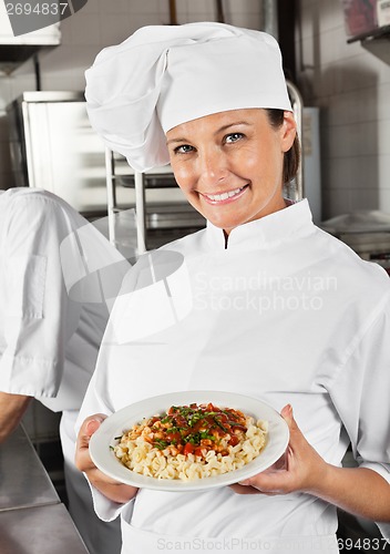 Image of Female Chef Showing Pasta Dish