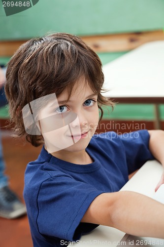 Image of Little Boy Smiling At Desk