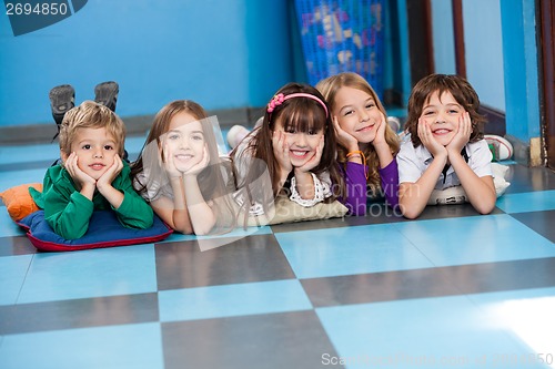 Image of Children Lying In A Row On Floor