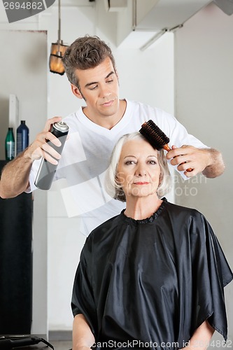Image of Woman With Hairdresser Styling Hair At Salon
