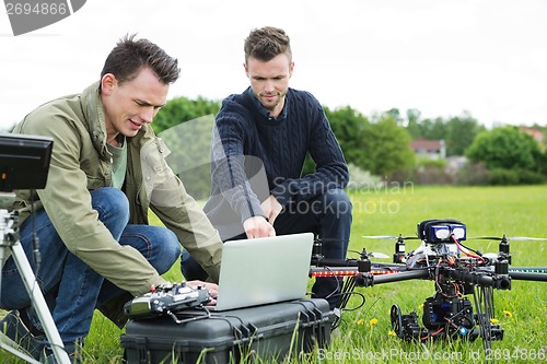 Image of Technicians Using Laptop By UAV Drone