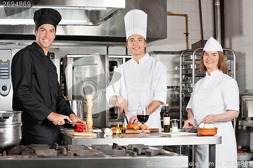 Image of Chefs Working In Industrial Kitchen