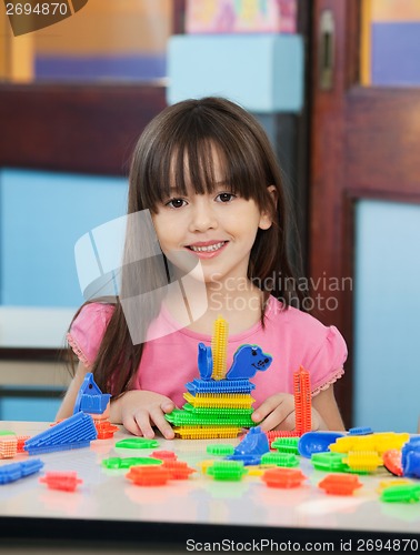 Image of Little Girl With Construction Blocks In Classroom