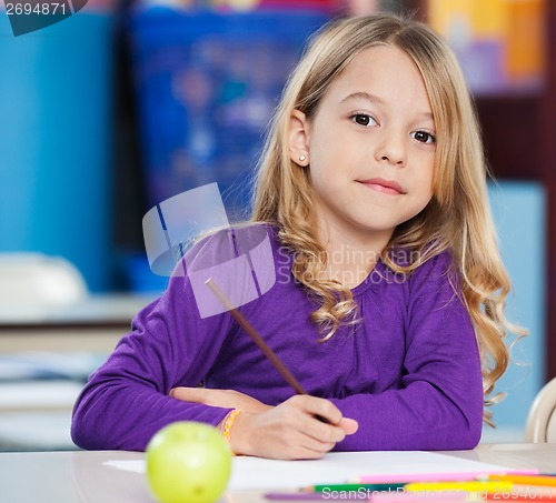 Image of Cute Girl With Sketch Pen And Paper At Desk