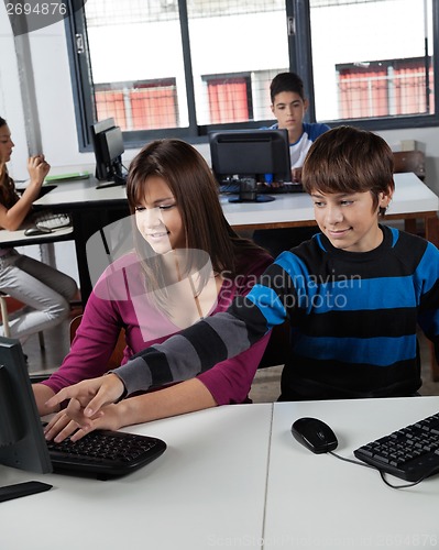 Image of Teenage Schoolboy Pointing At Computer Monitor