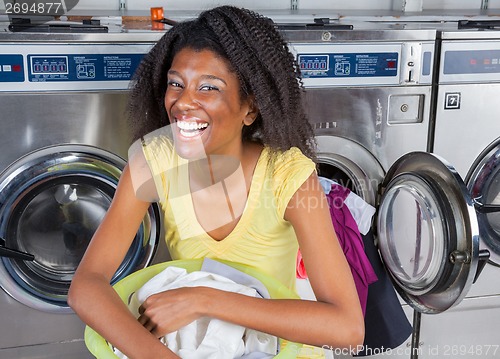 Image of Cheerful Woman With Laundry Basket