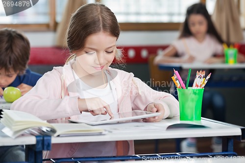 Image of Schoolgirl Using Digital Tablet In Classroom