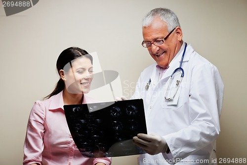 Image of Radiologist Showing X-ray To Patient
