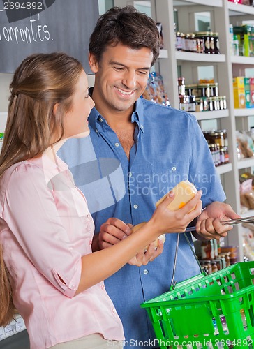 Image of Couple With Cheese Shopping In Grocery Store