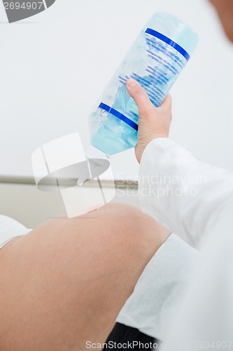 Image of Gynecologist Applying Ultrasound Gel On Pregnant Woman's Belly