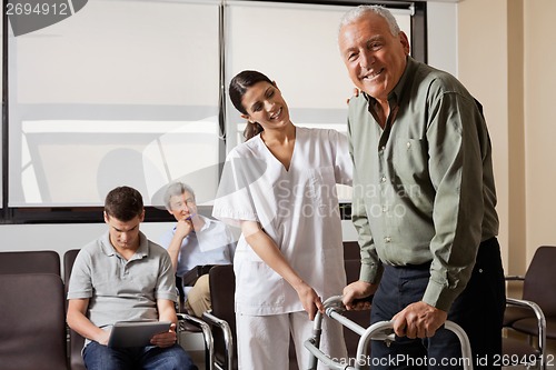 Image of Nurse Helping Senior Patient With Walker