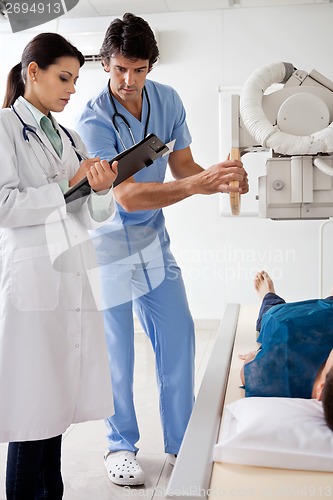 Image of Radiologists With Patient In X-ray Room