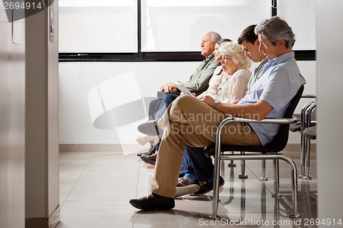Image of People Waiting For Doctor In Hospital Lobby