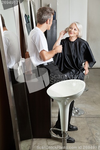 Image of Hairstylist Listening To Female Client