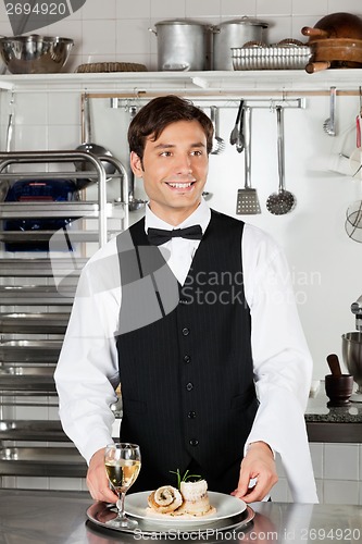 Image of Waiter With Salmon Roll And White Wine