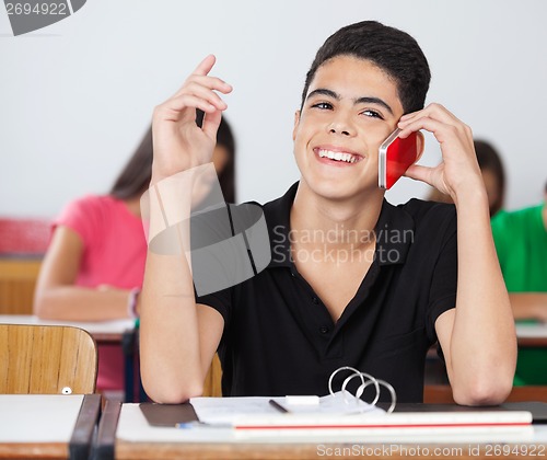 Image of Male Student Looking Away While Talking On Phone