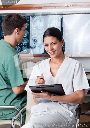 Image of Female Medical Technician Holding Clipboard