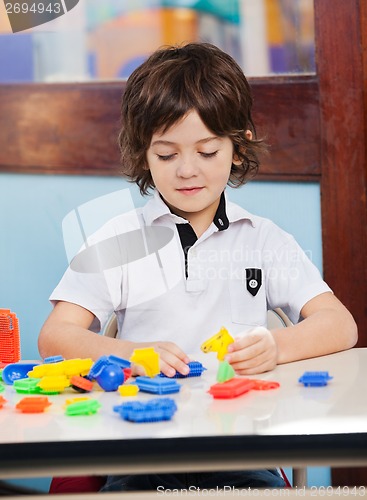 Image of Boy Playing With Blocks In Classroom