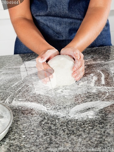 Image of Female Chef Kneading Dough