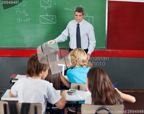 Image of Students Using Tablet And Calculator