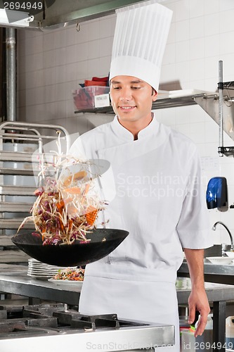 Image of Chef Tossing Vegetables in Wok