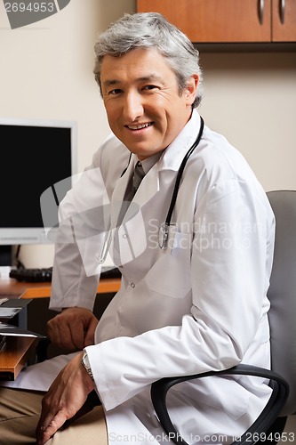 Image of Male Doctor Sitting On Chair At Clinic