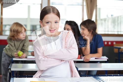 Image of Little Girl Standing Arms Crossed At Desk