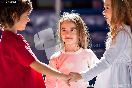 Image of Girl Looking At Friend While Playing In Kindergarten