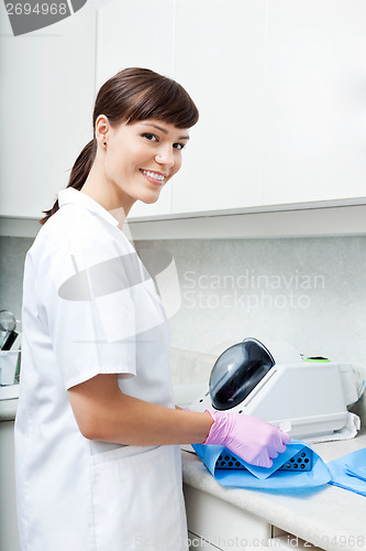 Image of Female Dentist Steralizing Tools