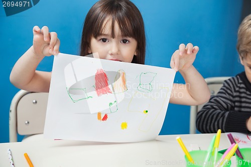 Image of Girl Holding Drawing Paper In Art Class