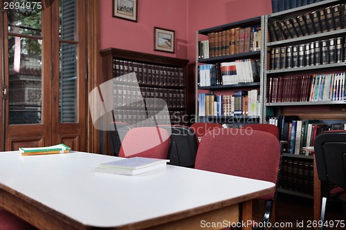 Image of Chairs At Table With Bookshelf In Library