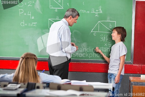 Image of Schoolboy Asking Question To Teacher While Solving Mathematics