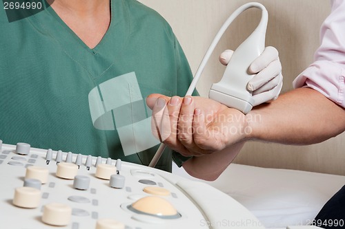 Image of Technician Scanning Male Patient's Hand