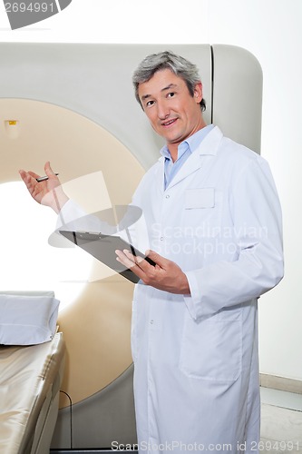 Image of Doctor Presenting The CT Scan Machine