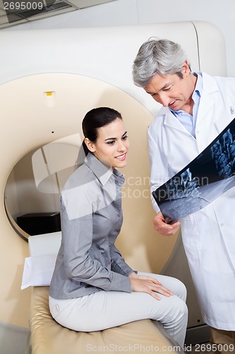 Image of Radiologist Showing X-ray To Female Patient